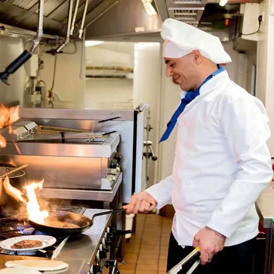 The Savoy Chef Created Meals, chef frying a dish.