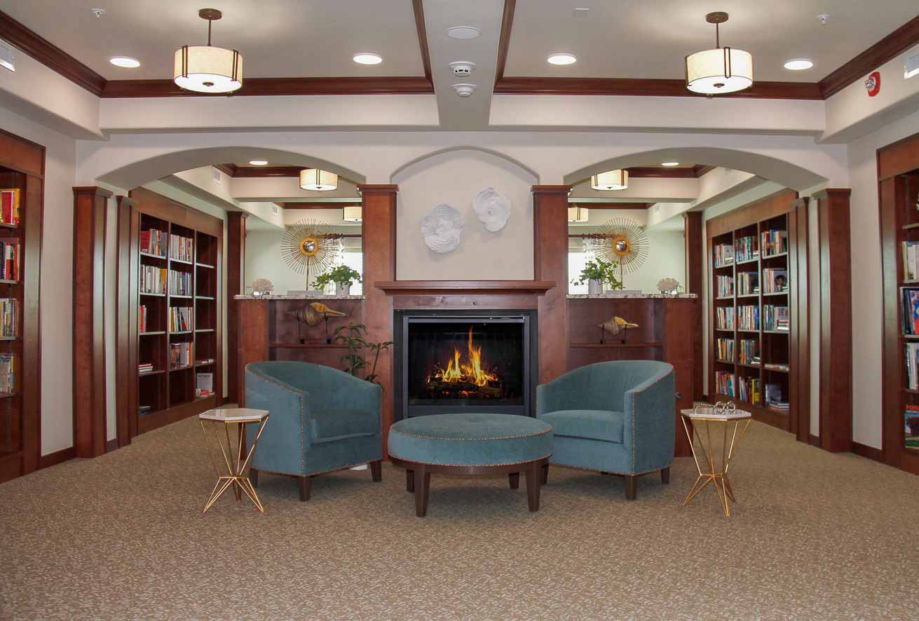 The library at The Savoy with shelves of books and comfortable seating