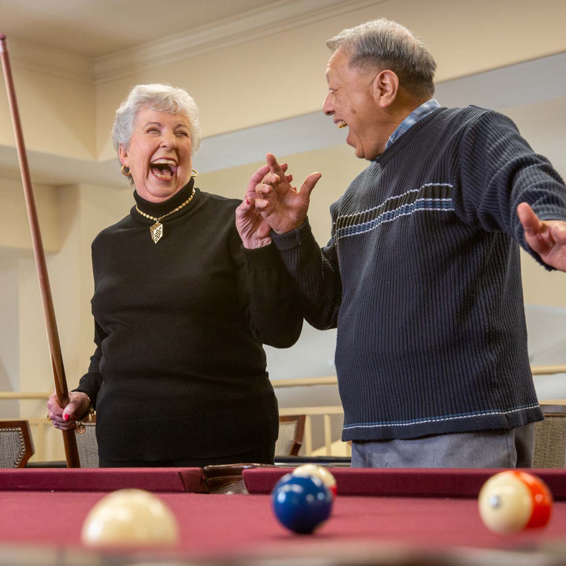 Residents playing billiards at The Savoy